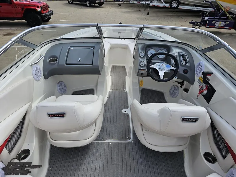 Slide: The Image of Interior of a 2010 Larson Senza 186 boat with white seating and dashboard. - 42