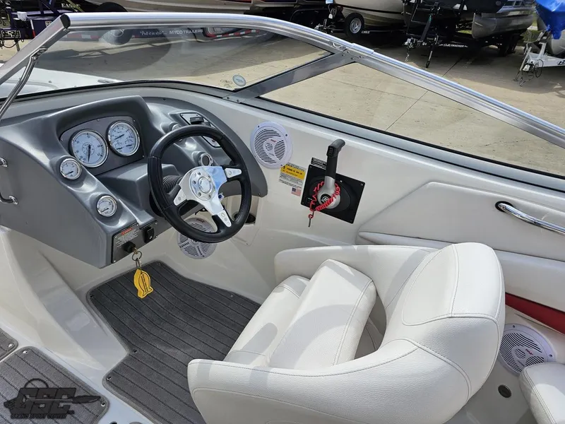 Slide: The Image of Interior of a 2010 Larson Senza 186 boat, featuring steering wheel and dashboard controls. - 45