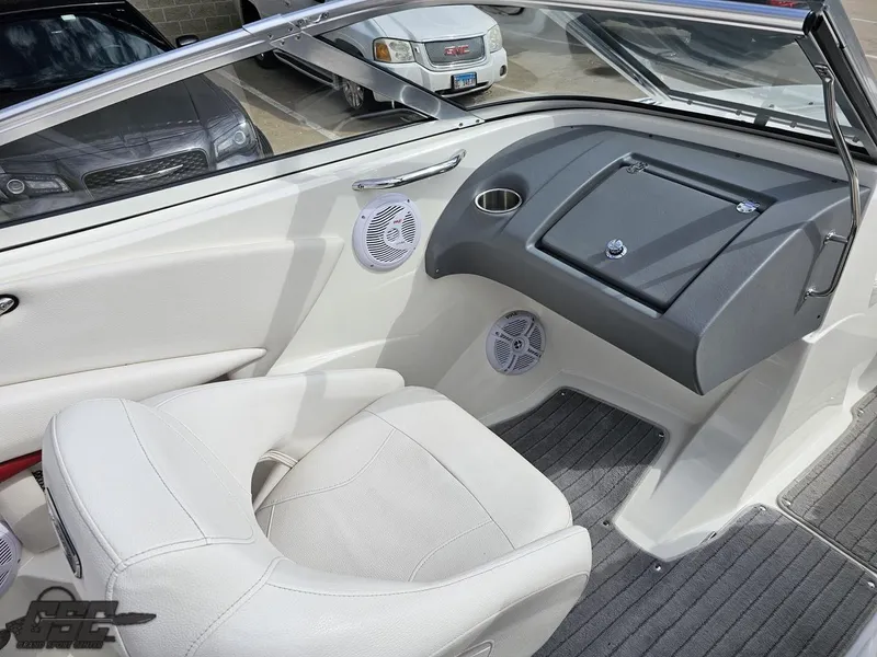 Slide: The Image of Interior of a 2010 Larson Senza 186 boat with white seating and dashboard. - 48