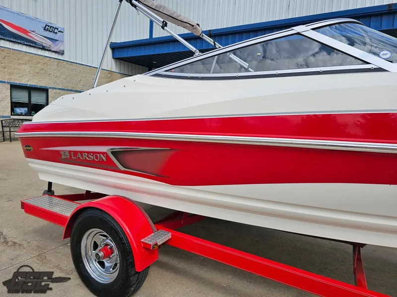 Slide: The Image of 2010 Larson Senza 186 boat with red and white design on a trailer. - 9