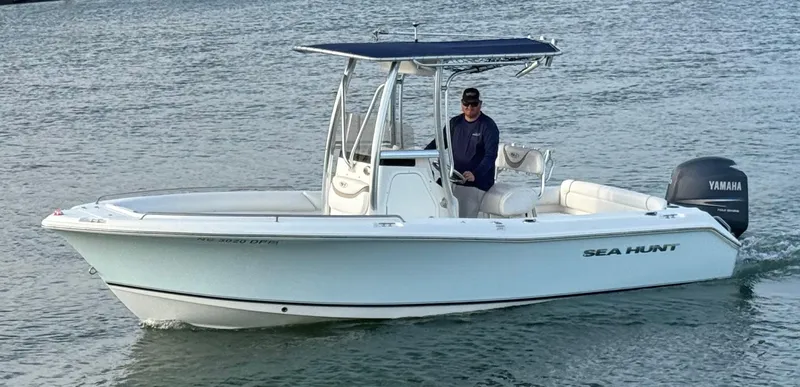 Slide: The Image of 2010 Sea Hunt Ultra 210 boat with Yamaha engine on calm water. - 0