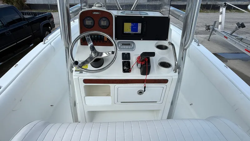 Slide: The Image of 2010 Sea Hunt Ultra 210 boat console with steering wheel, gauges, and navigation system. - 14