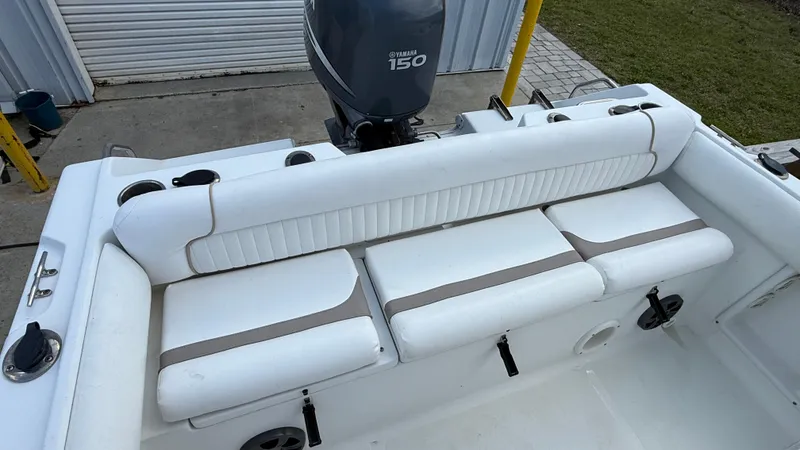 Slide: The Image of 2010 Sea Hunt Ultra 210 boat with Yamaha 150 engine, featuring white cushioned seating. - 15