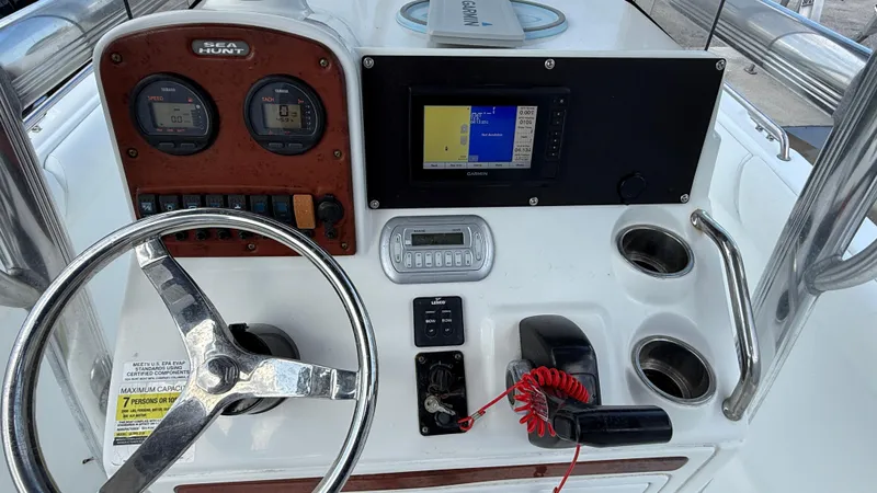 Slide: The Image of Control panel of a 2010 Sea Hunt Ultra 210 boat with steering wheel and navigation system. - 23