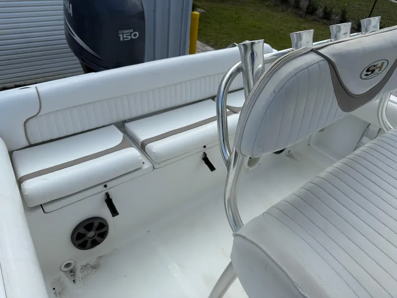 Slide: The Image of 2010 Sea Hunt Ultra 210 boat interior with white seating and Yamaha 150 engine. - 24