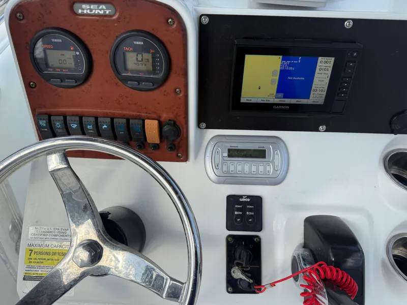 Slide: The Image of Dashboard of a 2010 Sea Hunt Ultra 210 boat with gauges and navigation system. - 26