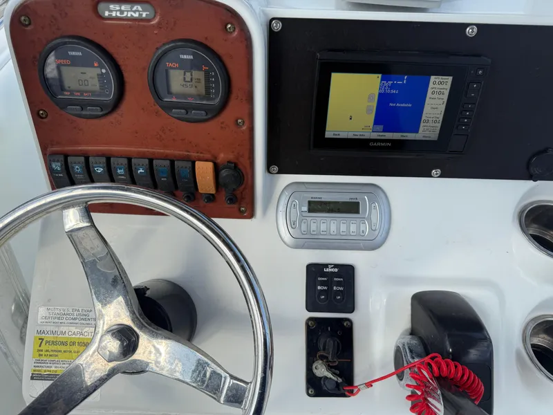 Slide: The Image of 2010 Sea Hunt Ultra 210 dashboard with steering wheel, gauges, and navigation system. - 27