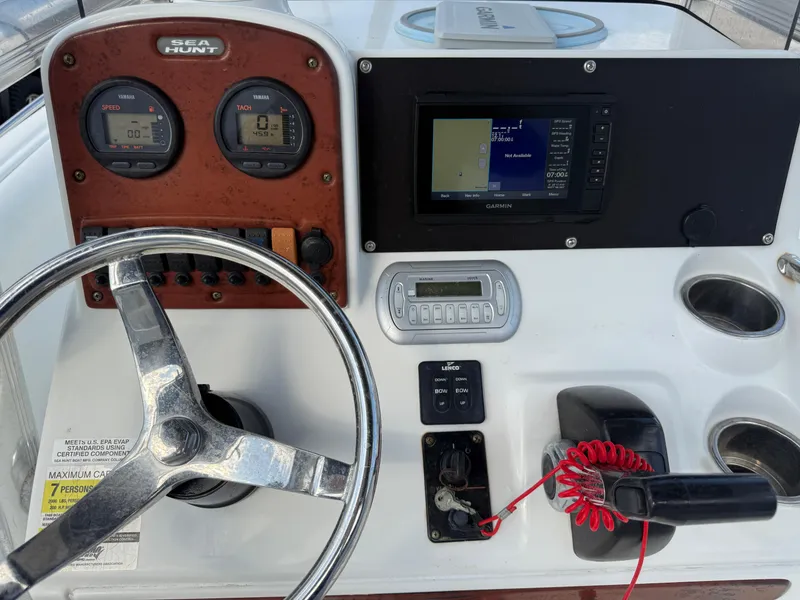 Slide: The Image of Control panel of a 2010 Sea Hunt Ultra 210 boat with steering wheel and gauges. - 28