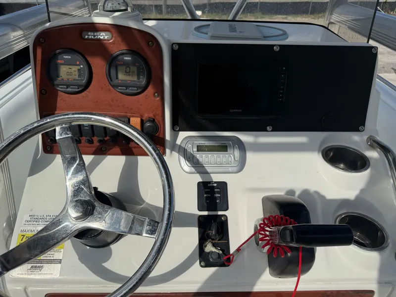 Slide: The Image of 2010 Sea Hunt Ultra 210 boat dashboard with steering wheel and control panel. - 31