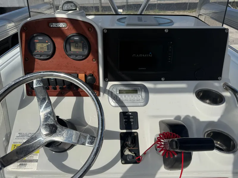 Slide: The Image of 2010 Sea Hunt Ultra 210 boat dashboard with Garmin GPS and steering wheel. - 32