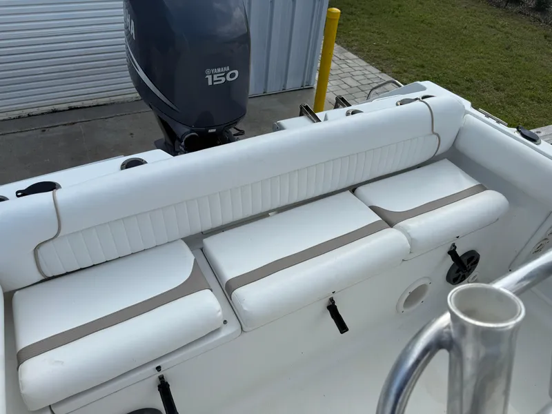 Slide: The Image of 2010 Sea Hunt Ultra 210 boat with Yamaha 150 engine, featuring white cushioned seating. - 35