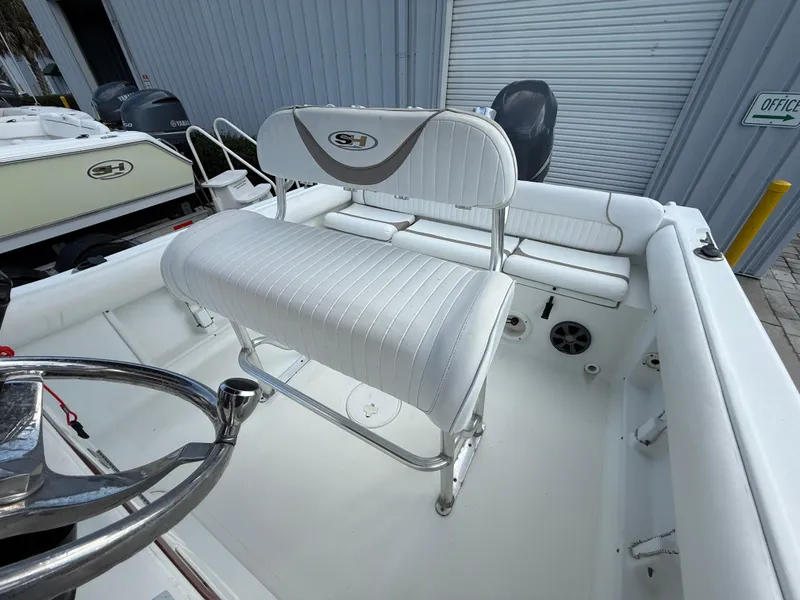 Slide: The Image of 2010 Sea Hunt Ultra 210 boat interior with white seating and steering wheel. - 39