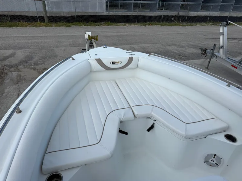 Slide: The Image of 2010 Sea Hunt Ultra 210 boat with white cushioned seating in the bow area. - 41