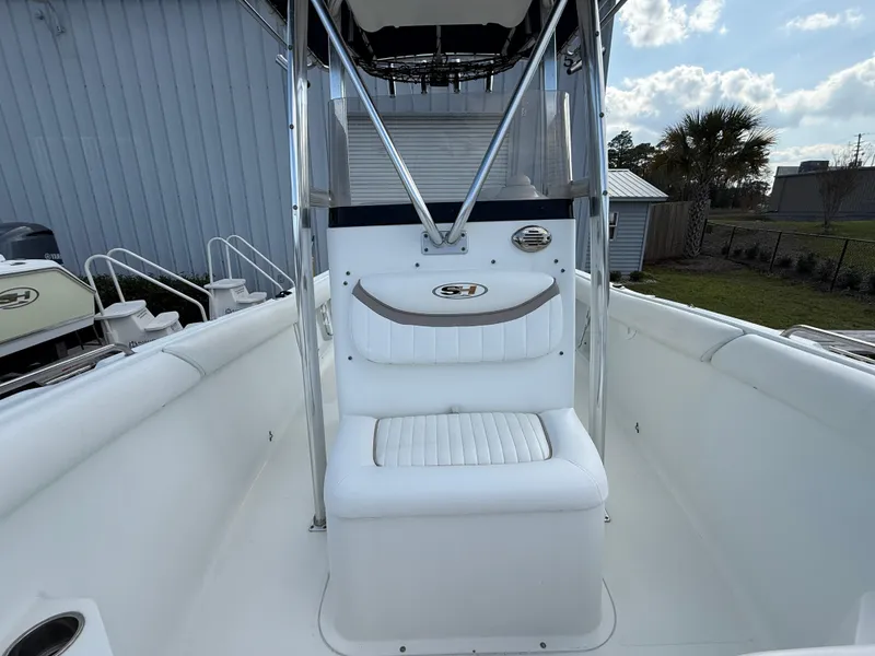 Slide: The Image of 2010 Sea Hunt Ultra 210 boat interior with white seating and console. - 42
