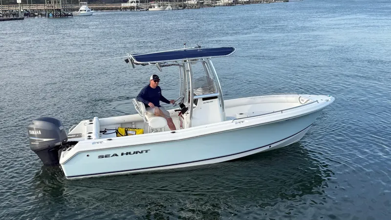 Slide: The Image of 2010 Sea Hunt Ultra 210 boat on water with Yamaha outboard motor. - 45