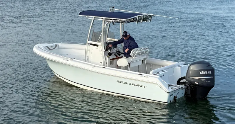 Slide: The Image of 2010 Sea Hunt Ultra 210 boat with Yamaha engine on calm water. - 5