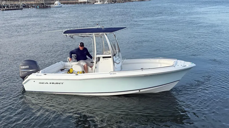 Slide: The Image of 2010 Sea Hunt Ultra 210 boat on water with Yamaha engine. - 7