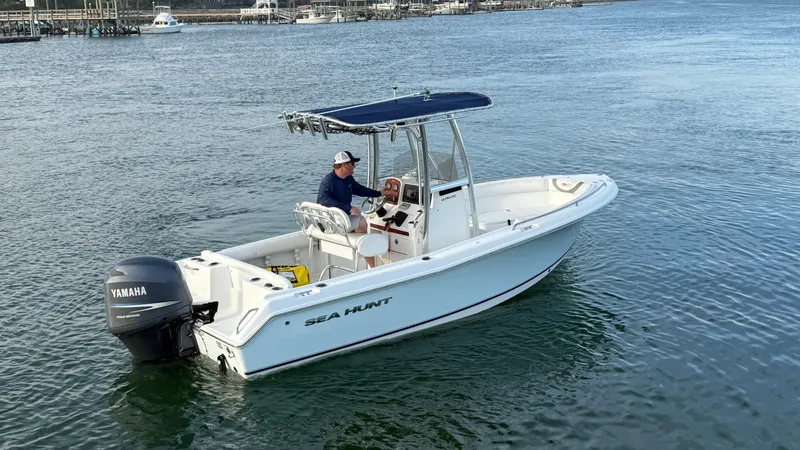 Slide: The Image of 2010 Sea Hunt Ultra 210 boat with Yamaha engine on calm water. - 8