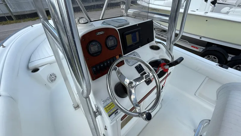 Slide: The Image of 2010 Sea Hunt Ultra 210 boat console with steering wheel and gauges. - 9