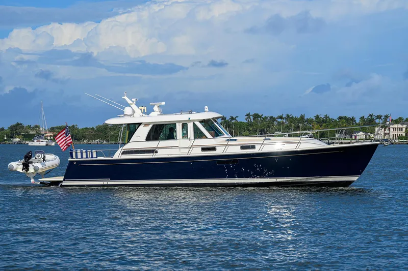 Slide: The Image of 2018 Sabre 48 Salon Express yacht cruising on a sunny day with a scenic backdrop. - 0