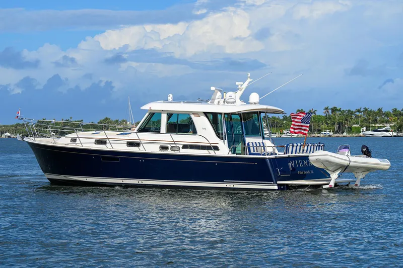 Slide: The Image of 2018 Sabre 48 Salon Express yacht cruising on a sunny day with American flag. - 10