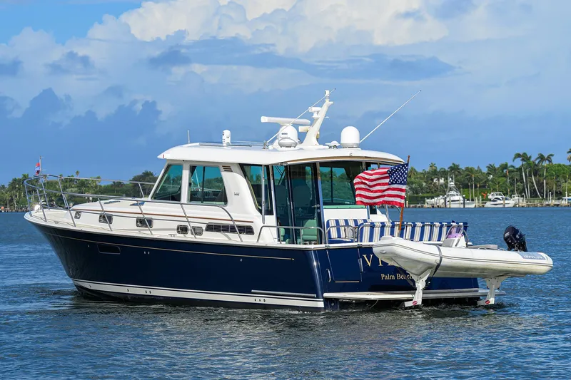 Slide: The Image of 2018 Sabre 48 Salon Express yacht on water with American flag. - 11