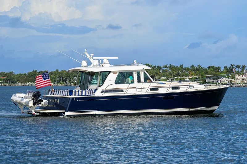 Slide: The Image of 2018 Sabre 48 Salon Express yacht cruising on a sunny day with American flag. - 13