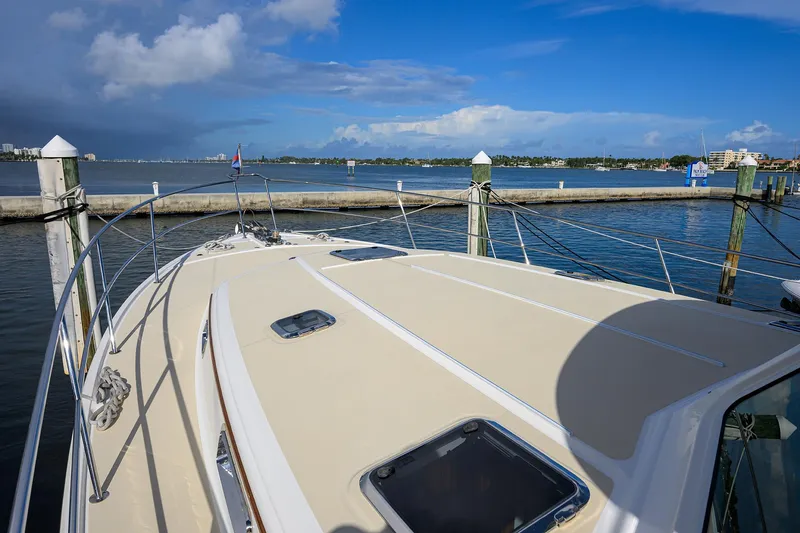 Slide: The Image of 2018 Sabre 48 Salon Express yacht docked at marina under blue sky. - 15