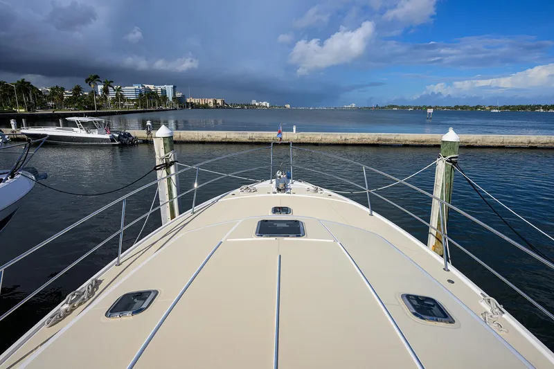 Slide: The Image of 2018 Sabre 48 Salon Express yacht docked with scenic waterfront view. - 16