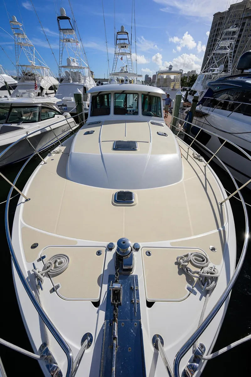 Slide: The Image of 2018 Sabre 48 Salon Express yacht docked, showcasing sleek design and luxury features. - 18