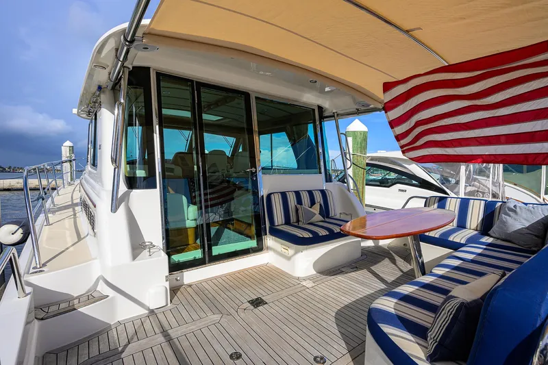 Slide: The Image of 2018 Sabre 48 Salon Express yacht with striped seating and American flag. - 30
