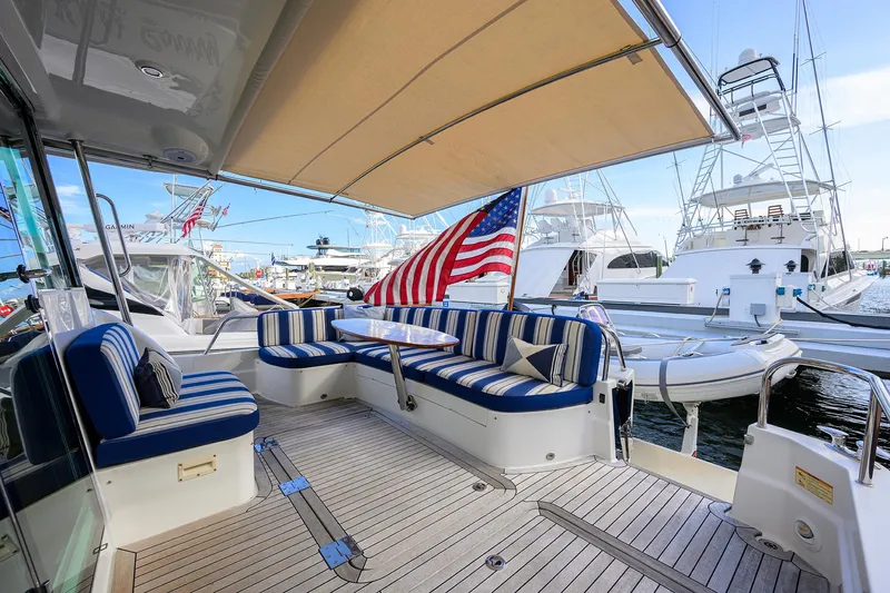 Slide: The Image of 2018 Sabre 48 Salon Express yacht with striped seating and American flag. - 31