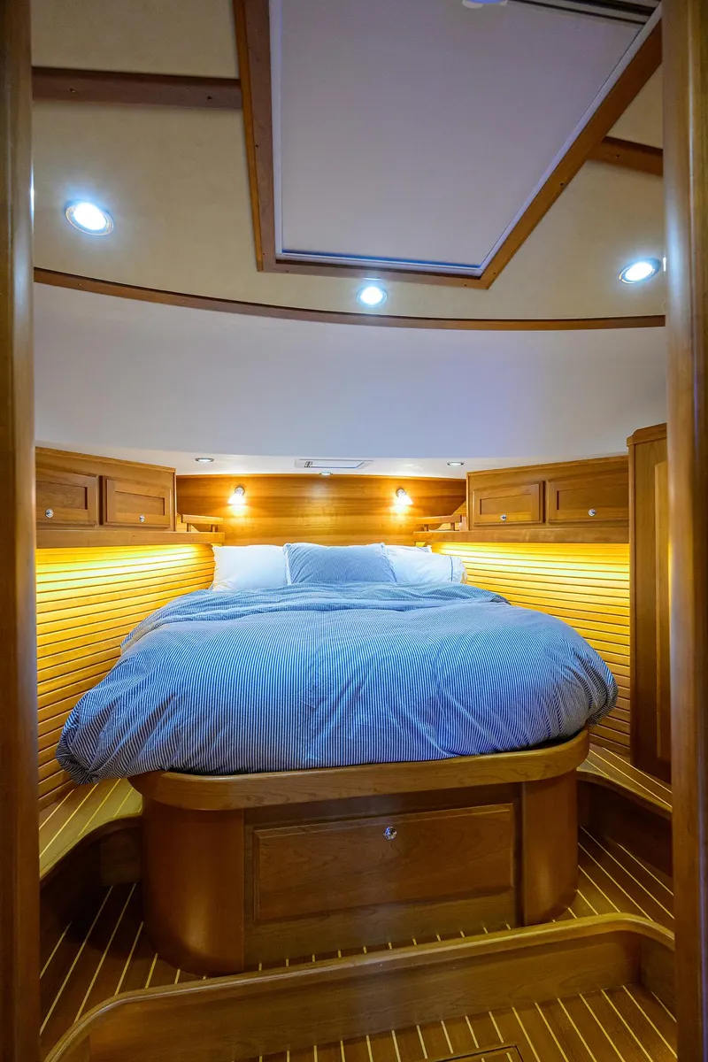 Slide: The Image of 2018 Sabre 48 Salon Express cabin with cozy bed and warm lighting. - 32