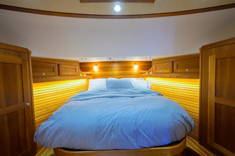 Slide: The Image of Luxurious cabin interior of 2018 Sabre 48 Salon Express with cozy bed and wooden accents. - 33