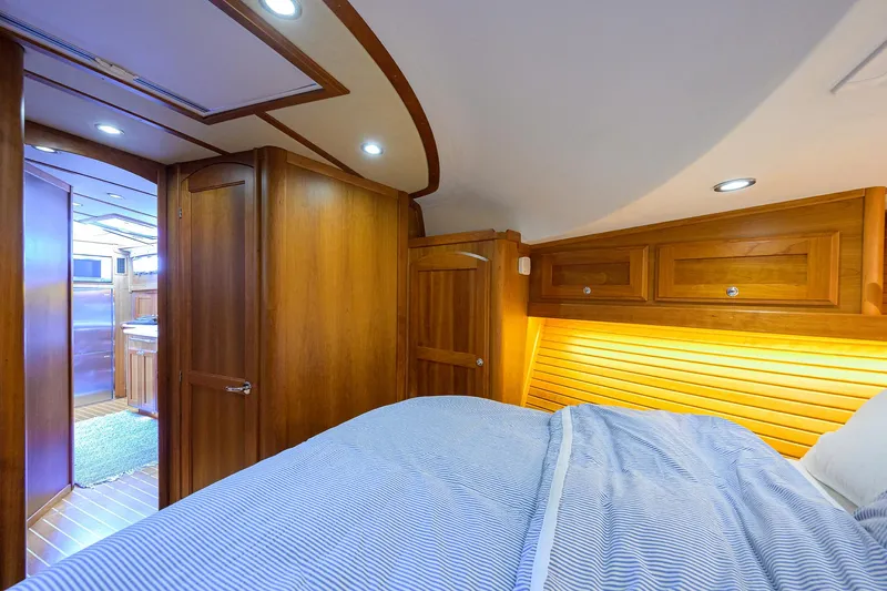 Slide: The Image of 2018 Sabre 48 Salon Express cabin with wooden interior and cozy bedding. - 35