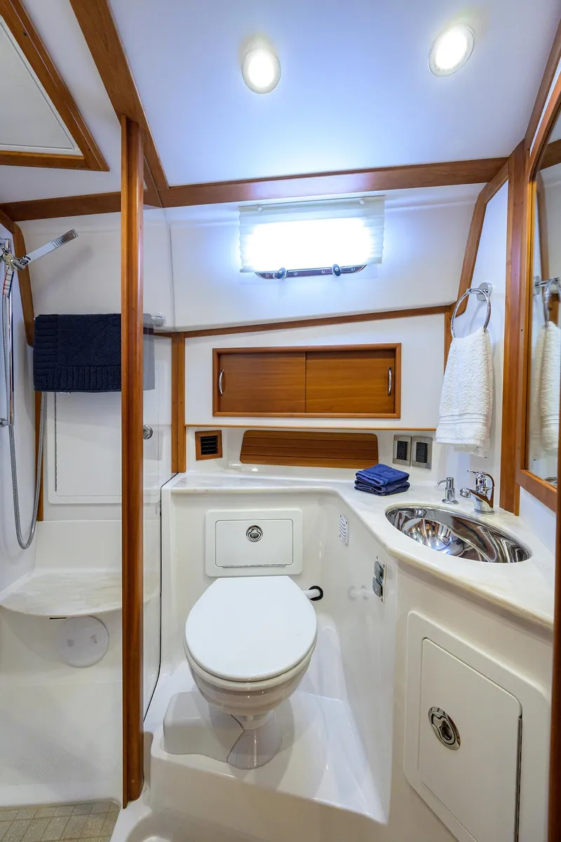Slide: The Image of 2018 Sabre 48 Salon Express bathroom with modern fixtures and wooden accents. - 36