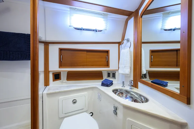 Slide: The Image of 2018 Sabre 48 Salon Express bathroom with modern fixtures and wooden accents. - 38