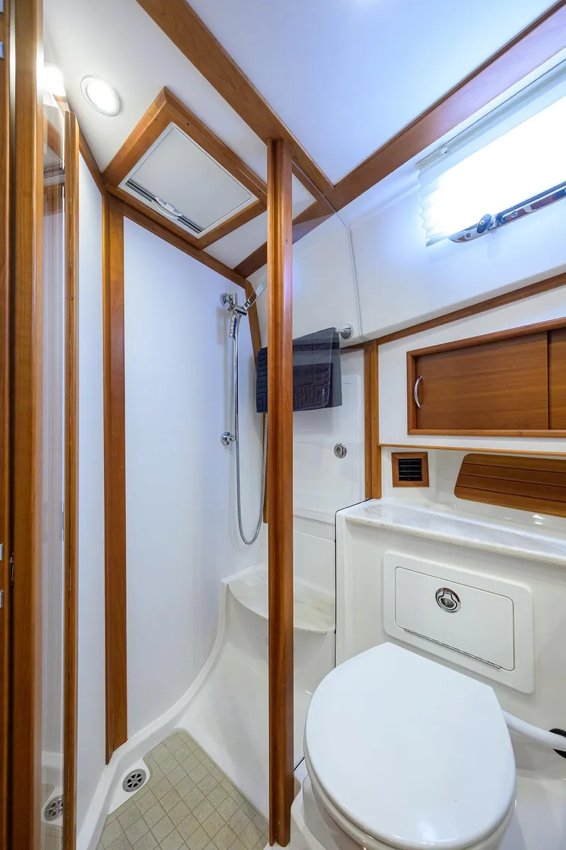 Slide: The Image of 2018 Sabre 48 Salon Express bathroom with shower, wooden accents, and modern fixtures. - 39