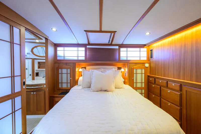 Slide: The Image of Luxurious bedroom interior of 2018 Sabre 48 Salon Express yacht with wood paneling and ambient lighting. - 40