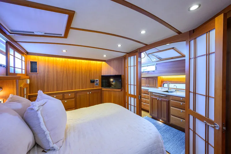 Slide: The Image of Luxurious 2018 Sabre 48 Salon Express bedroom with wood paneling and ensuite bathroom. - 42