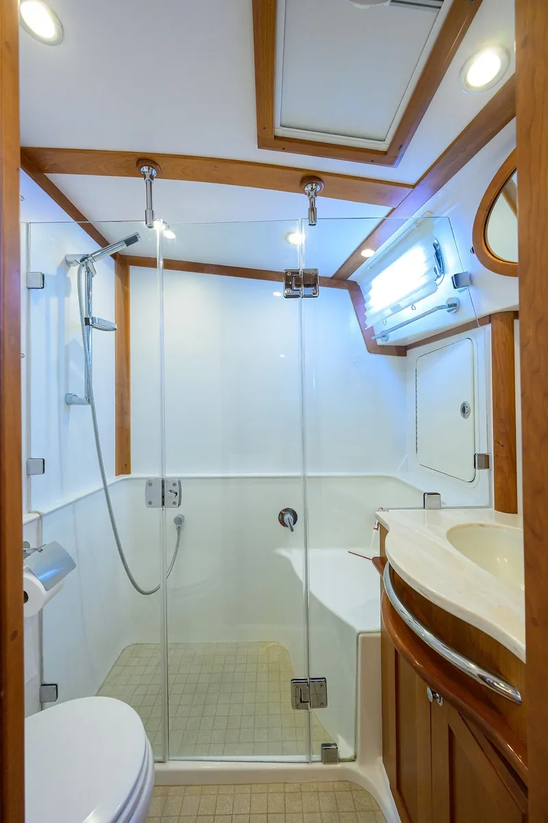 Slide: The Image of 2018 Sabre 48 Salon Express bathroom with glass shower, wooden accents, and modern fixtures. - 47