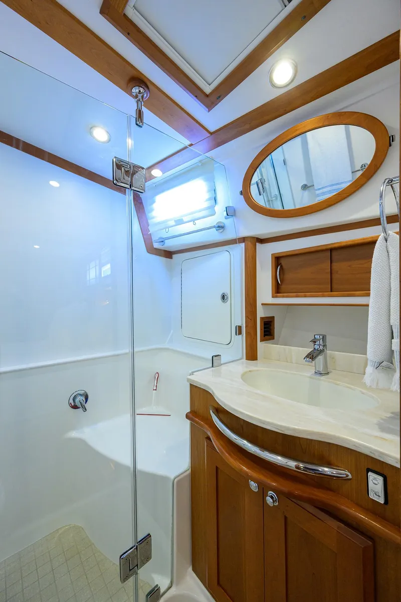 Slide: The Image of 2018 Sabre 48 Salon Express bathroom with modern fixtures and wooden accents. - 48