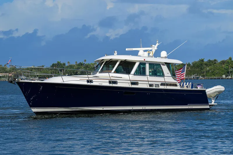 Slide: The Image of 2018 Sabre 48 Salon Express yacht cruising on a calm blue sea. - 6