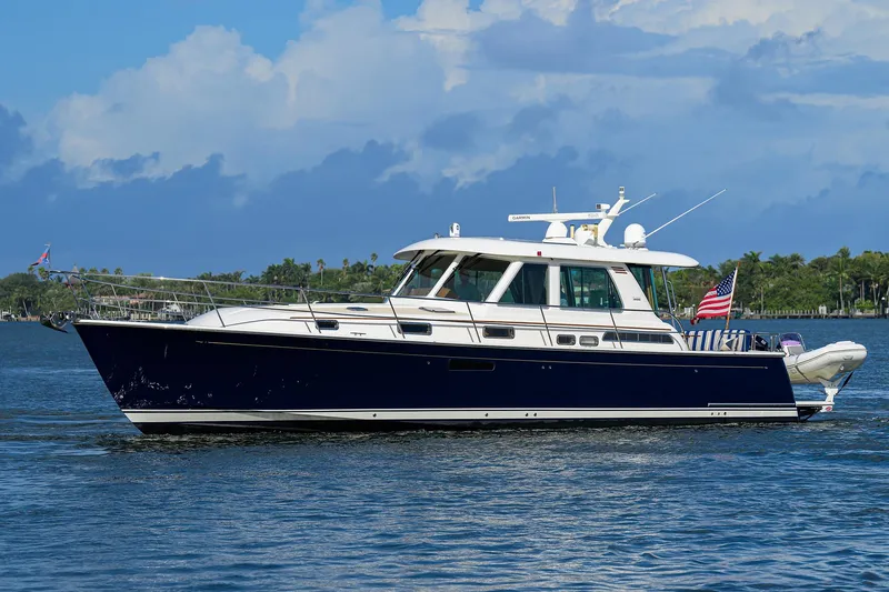 Slide: The Image of 2018 Sabre 48 Salon Express yacht cruising on a calm blue sea. - 7