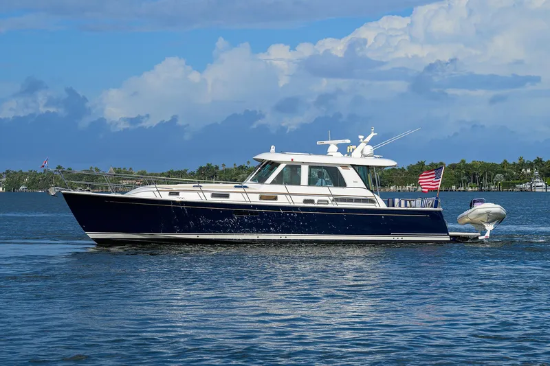 Slide: The Image of 2018 Sabre 48 Salon Express yacht cruising on a sunny day with clear skies. - 9