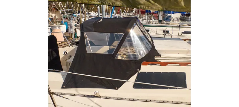 Slide: The Image of 1980 Sceptre 36 Brandywine sailboat with black canvas cover in marina. - 10