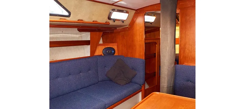 Slide: The Image of Interior of 1980 Sceptre 36 Brandywine yacht with blue seating and wooden accents. - 39