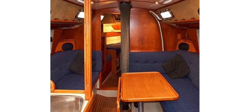 Slide: The Image of Interior of 1980 Sceptre 36 Brandywine yacht with wooden furnishings and blue seating. - 40