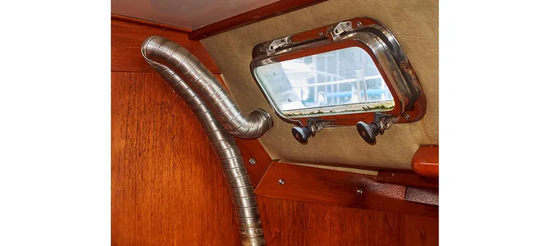 Slide: The Image of Interior of 1980 Sceptre 36 Brandywine yacht, featuring a porthole and metal ventilation duct. - 41
