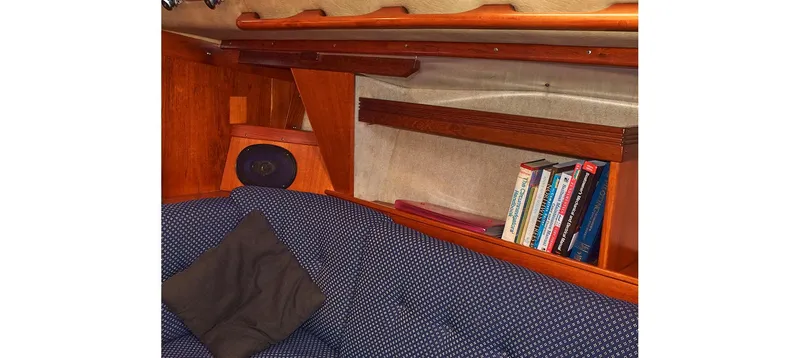 Slide: The Image of Cozy cabin interior of 1980 Sceptre 36 Brandywine with books and cushions. - 42